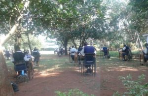 The students of Inungo Mixed Secondary School sitting for their examinations outside due to limited classrooms